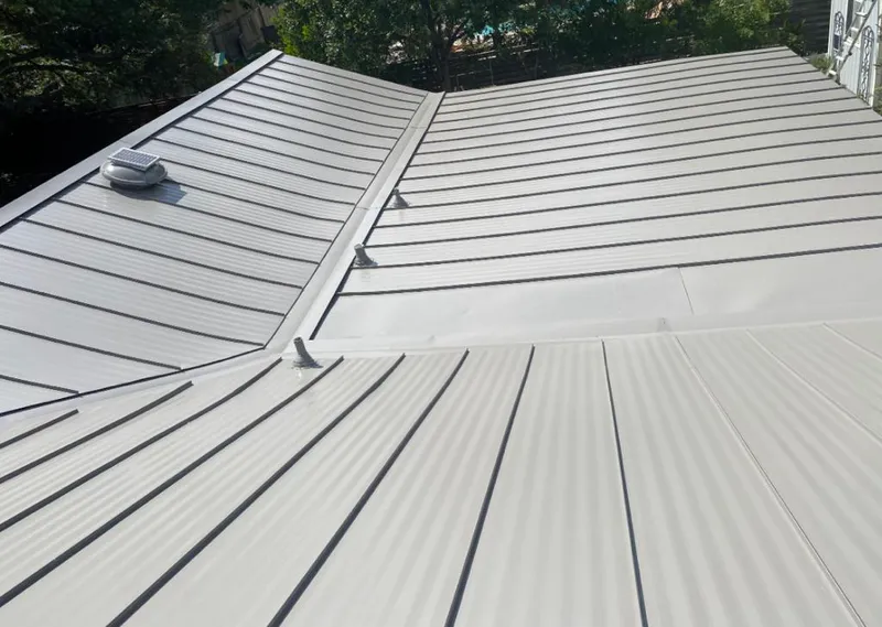 Solar attic fan installed on a metal roof for Roof Ventilation in Summit